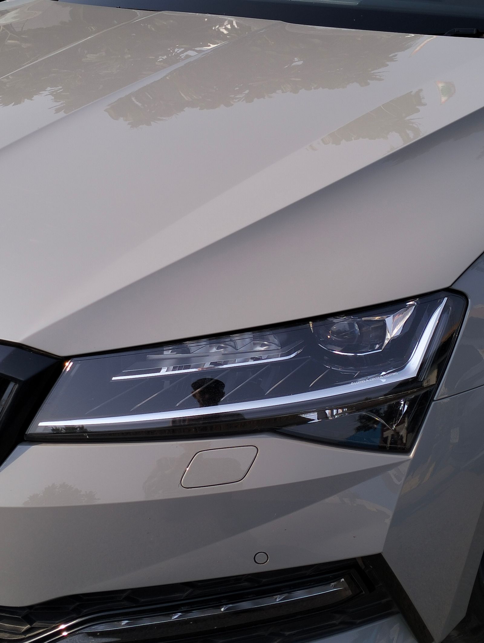Headlight lens close-up - reflective chrome detail after restoration