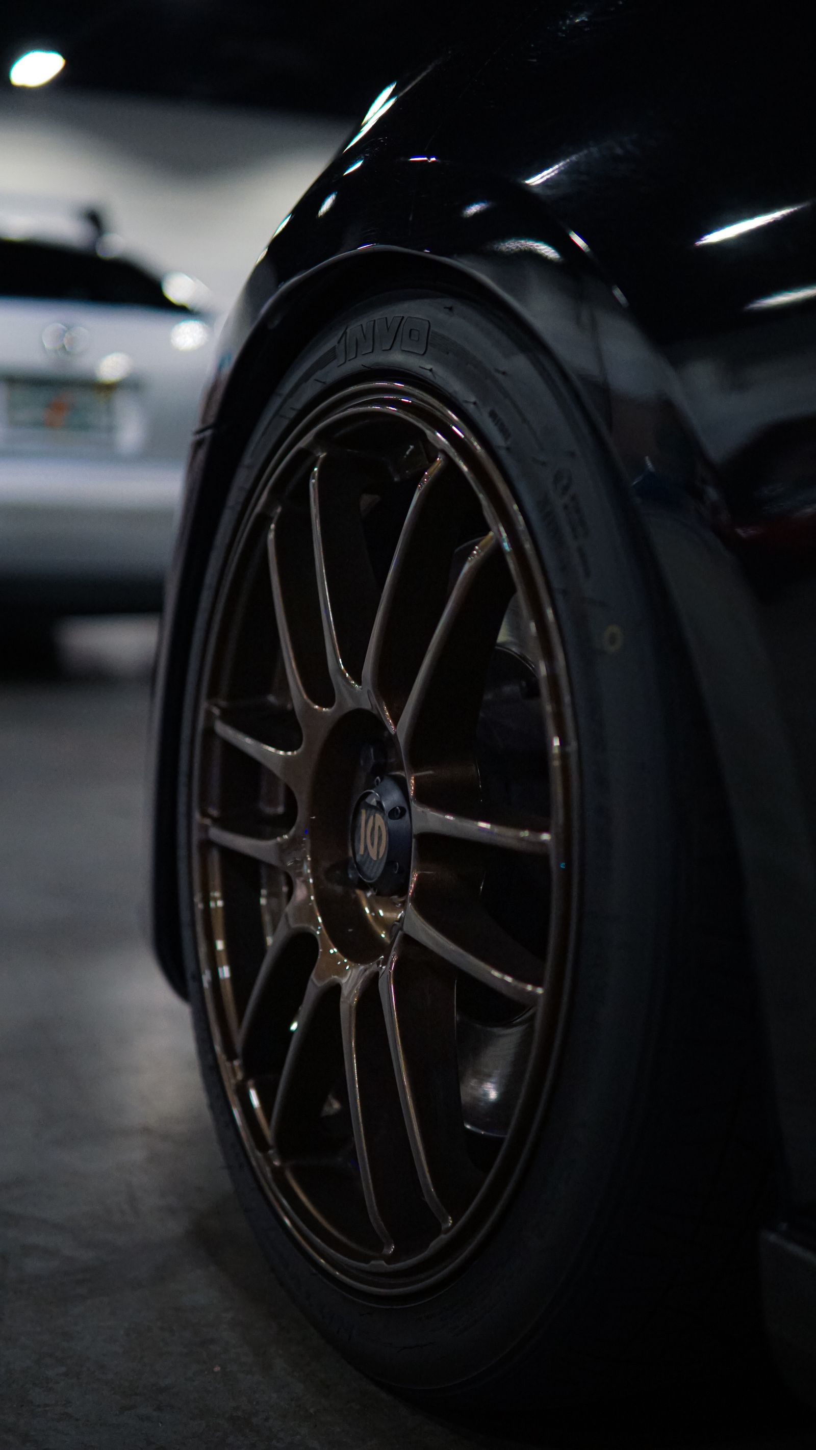 Wheel detail photograph - polished black alloy wheel after detailing