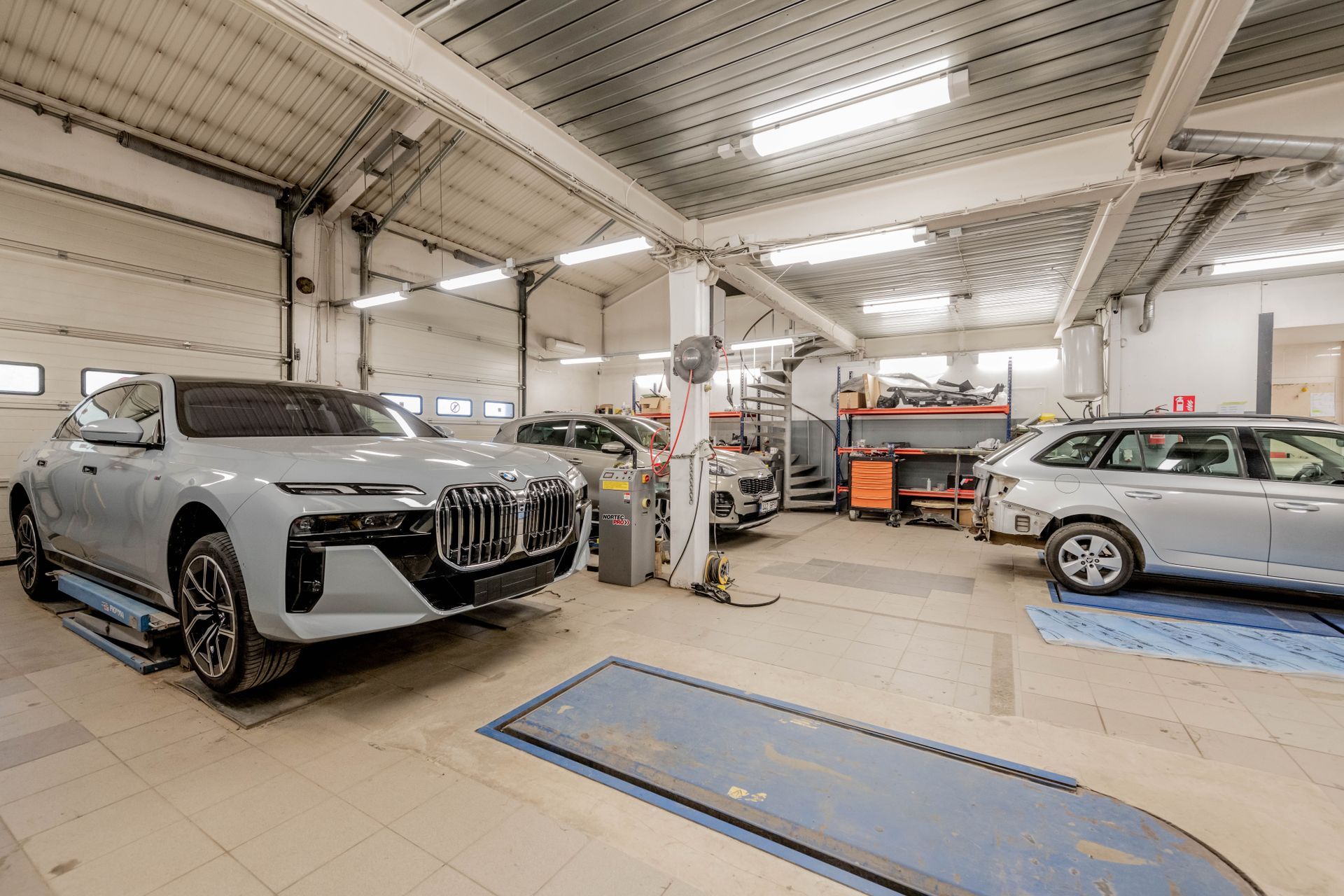 Professional automotive detailing studio with luxury vehicles